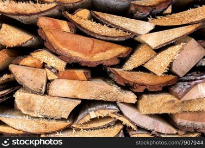 Closeup texture of freshly chopped wood planks stacked in pile