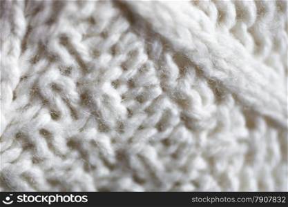 Closeup texture of white knitted woolen sweater