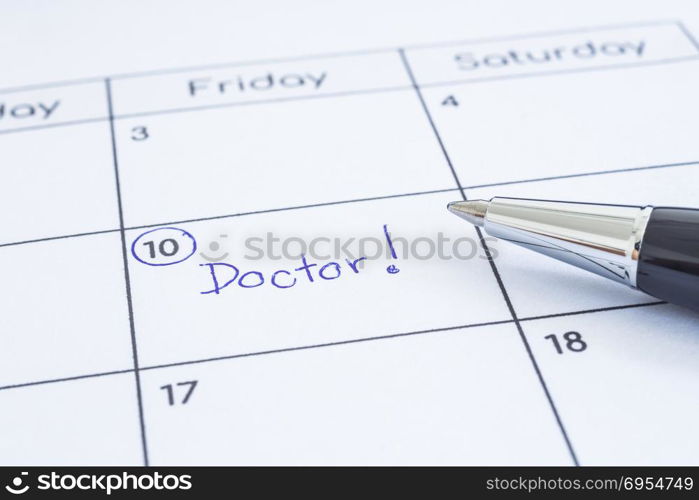 Closeup the blue wordADoctor written on timetable with circle mark. Modern pen put on calendar sheet, blurred at edges. Health reminder note, hospital schedule, appointment date, time management.