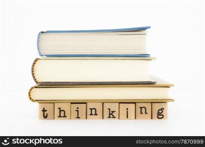 closeup thinking wording and books isolate on white background, concept and idea for business