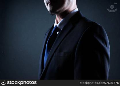 Closeup three quarter front view of businessman with black background