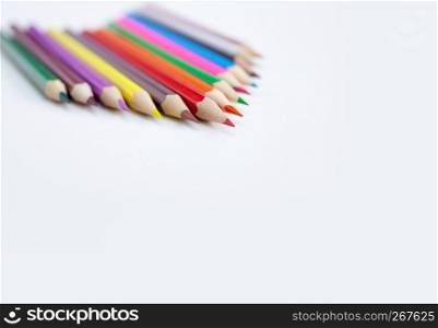 Closeup tips of colorful pencils with selected focus on white background with copy space. Drawing, Art, Creativity concept.