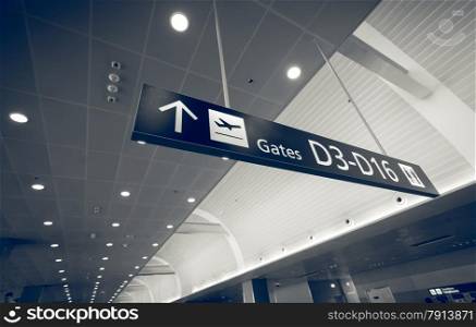 Closeup toned shot of gate sign in airport terminal