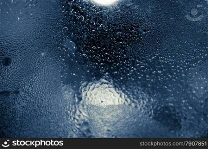 Closeup toned texture of water condensed on glass surface