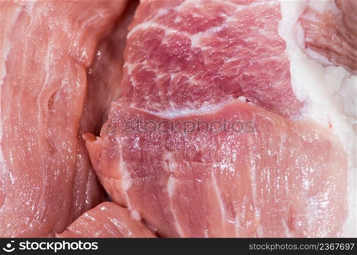 Closeup top view piece fresh raw meat of pork. Closeup pieces of raw pork meat