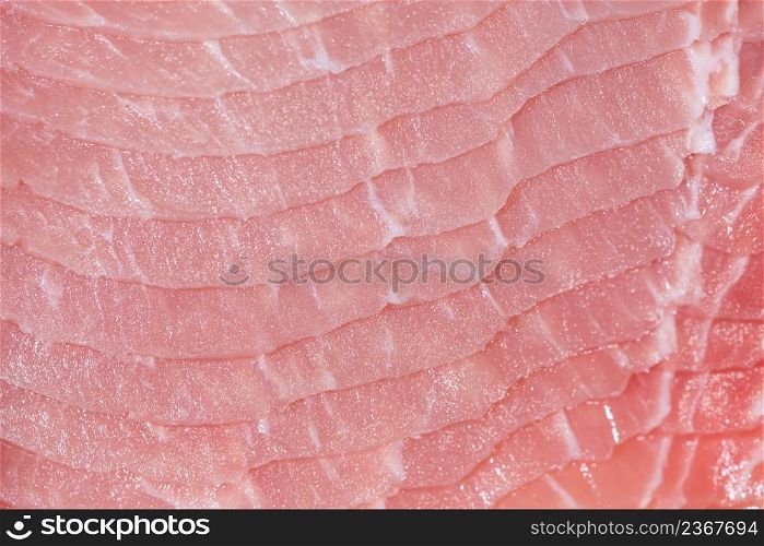 Closeup top view pieces raw meat of fresh pork slices are sliced into thin strips stacked on top of each other. Closeup fresh pork slices