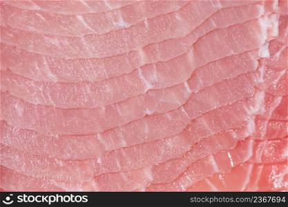 Closeup top view pieces raw meat of fresh pork slices are sliced into thin strips stacked on top of each other. Closeup fresh pork slices