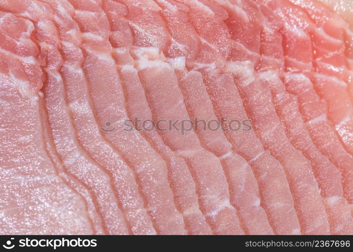 Closeup top view pieces raw meat of fresh pork slices are sliced into thin strips stacked on top of each other. Closeup fresh pork slices