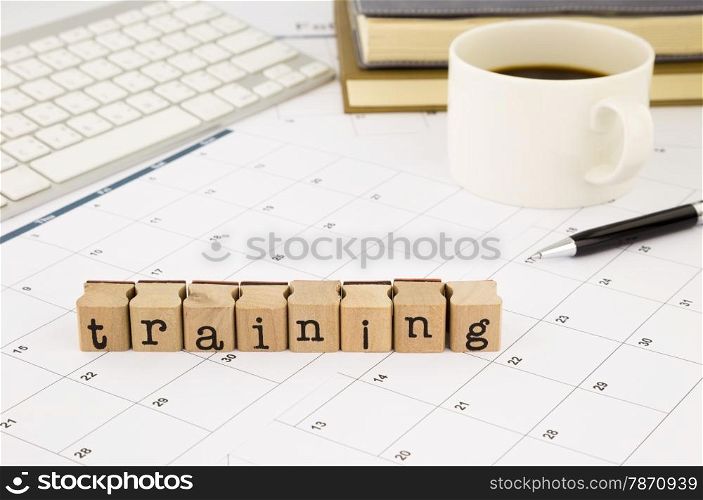 closeup training wording stack on office table, schedule and calendar for planing training course, business and education concept and idea