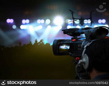 closeup Video Cameraman taking Concert crowd in silhouettes of Music fanclub with show hand action which follow up the songer at the front of stage with follow light, musical and concert concept