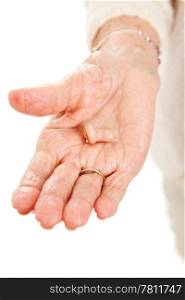 Closeup view of a hearing aid in the hand of a senior woman.