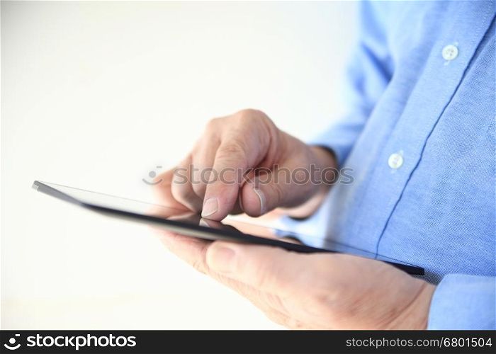 Closeup view of a man using a tablet