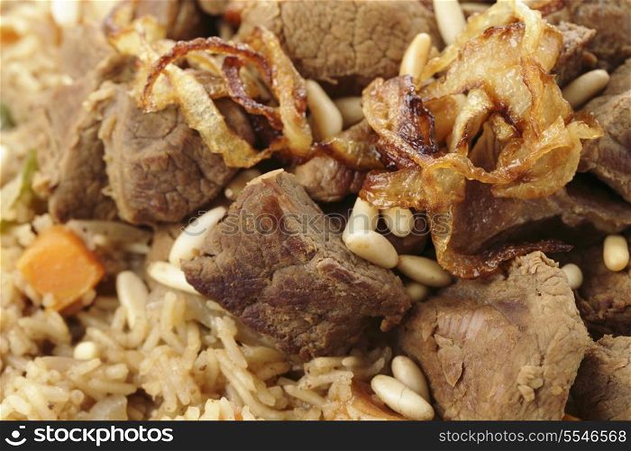 Closeup view of an Arab kabsa or machboos spiced meat and rice dish. This is a mainstay of cuisine in the Arabian peninsula and is vaguely similar to an indian biryani or an italian risotto