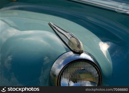 Closeup view of blinker and headlight of vintage car.