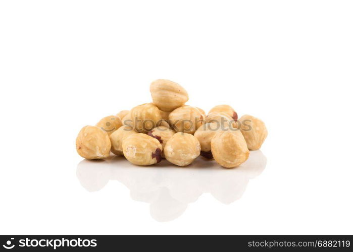 Closeup view of hazelnuts nuts pile on white background