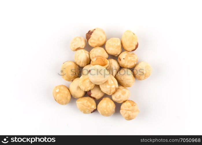 Closeup view of hazelnuts nuts pile on white background