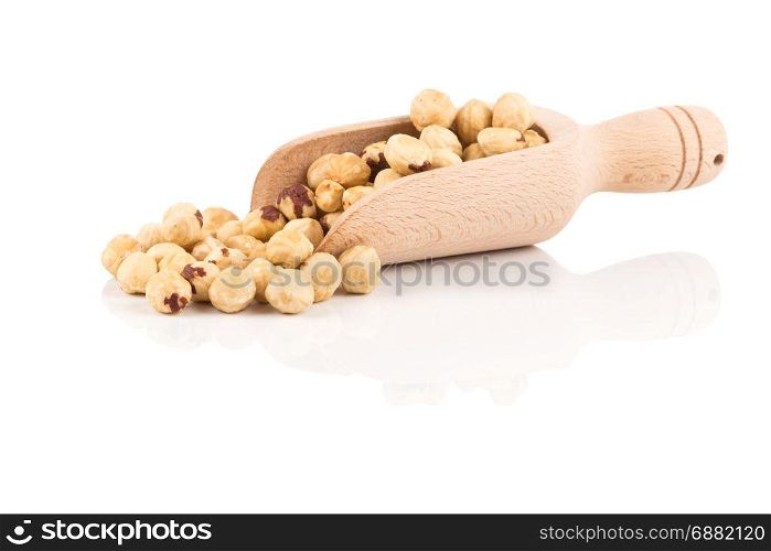 Closeup view of hazelnuts nuts pile on white background in wooden scoop