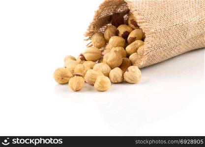 Closeup view of hazelnuts on white background in hessian bags