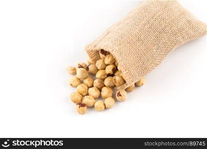 Closeup view of hazelnuts on white background in hessian bags