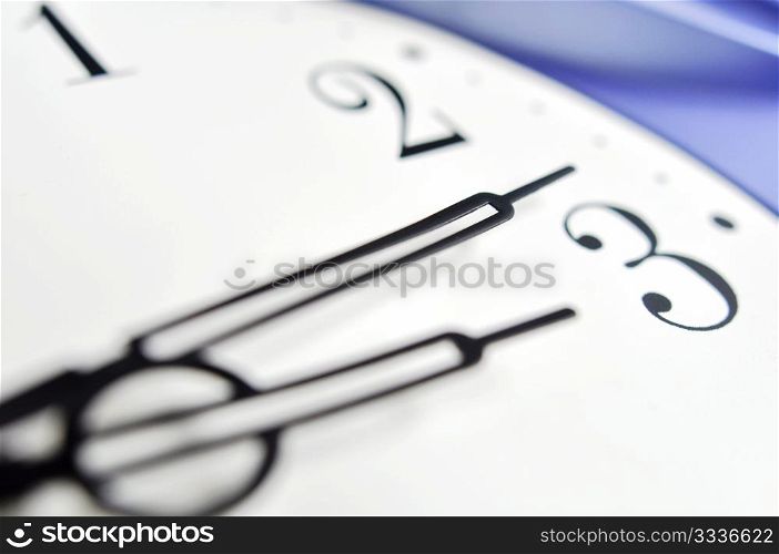Closeup view of hour,minute and second hands of a wall clock, shallow DOF