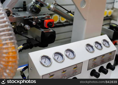 Closeup view of the automatic edge banding machine. Selective focus.