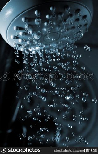closeup view of water flowing out of shower in dark