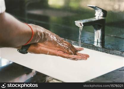 Closeup washing black man hands rubbing with soap and water in sinks to prevent outbreak coronavirus hygiene to stop spreading virus, hygiene for quarantine cleaning COVID-19 concept