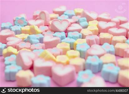 Closeup with selective focus colorful, pastel, sweet color of candy marshmallows on the pink background for web banner, brochure, leaflet, flyer template design