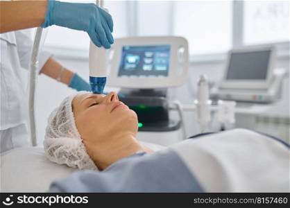 Closeup woman getting anti-aging cosmetic procedure in beauty salon. Satisfied female in disposable cap on couch at cosmetologist appointment. Closeup woman getting cosmetic procedure in beauty salon