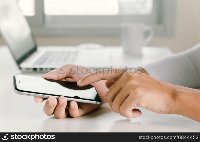 closeup woman hand using phone on workspace in office