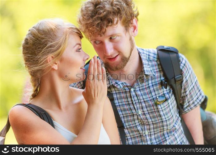 Closeup woman telling man her boyfriend some secrets, hiker couple talking outdoor
