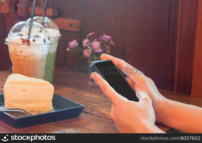 Closeup woman using smartphone in coffee shop, stock photo