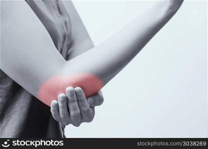 closeup women elbow pain/injury with red highlights on pain area. closeup women elbow pain/injury with red highlights on pain area with white backgrounds, healthcare and medical concept - B&W filter