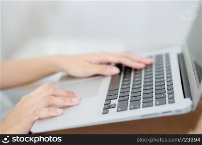 Closeup young asian woman using laptop for leisure on bedroom, girl working online with notebook freelance, business concept.