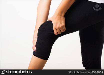 Closeup young woman aches to suffer from pain knee and she uses hand joint hold knee agony, studio shot isolated on white background Rheumatism healthcare and medical physiotherapy therapy concept