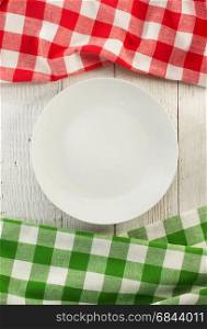 cloth napkin and plate on wood. cloth napkin and plate on wooden background