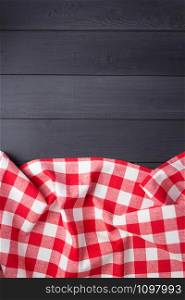 cloth napkin or tablecloth checked at rustic wooden plank board table background, top view
