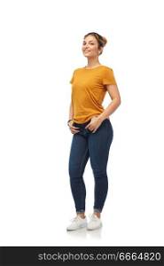 clothes and people concept - smiling young woman or teenage girl in orange t-shirt and jeans over white background. young woman or teenage girl in orange t-shirt