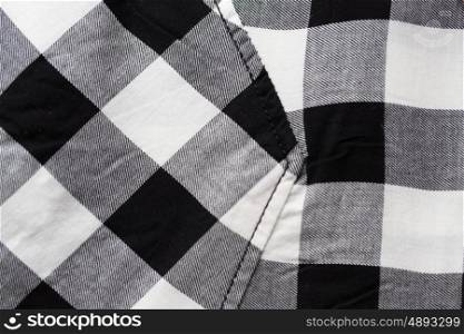 clothes and textile concept - close up of checkered clothing item with pocket. close up of checkered clothing item with pocket