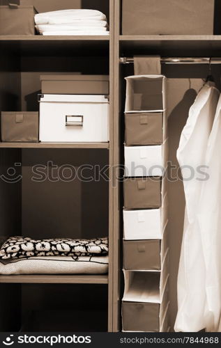 Clothes and towels in a wooden wardrobe