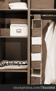 Clothes and towels in a wooden wardrobe