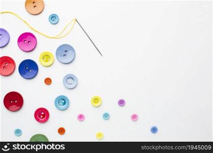 clothes colourful buttons with needle . High resolution photo. clothes colourful buttons with needle . High quality photo