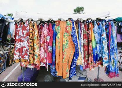 Clothes hanging in a market stall