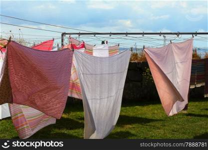 clothes hanging to dry on a laundry line blue sky background