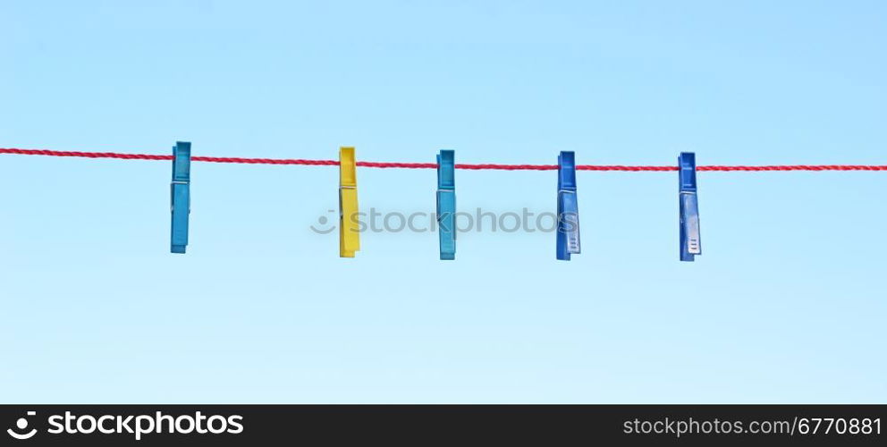 clothes pegs against sky background