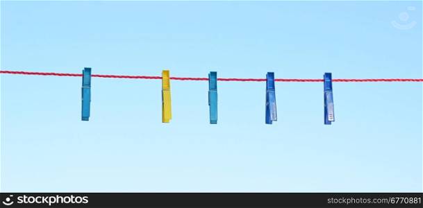 clothes pegs against sky background