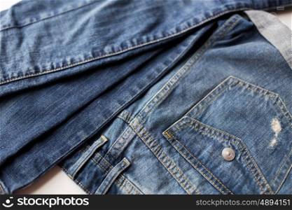 clothes, wear and fashion concept - close up of denim pants or jeans with pocket on white background. close up of denim pants or jeans with pocket