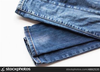 clothes, wear and fashion concept - denim pants or jeans on white background