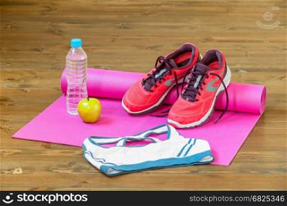 Clothing and footwear for fitness in the gym is located on the floor