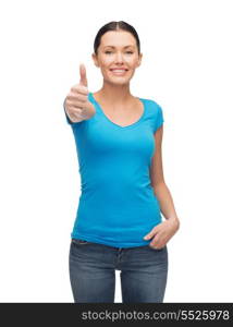 clothing design and happy people concept - smiling girl in blank blue t-shirt showing thumbs up